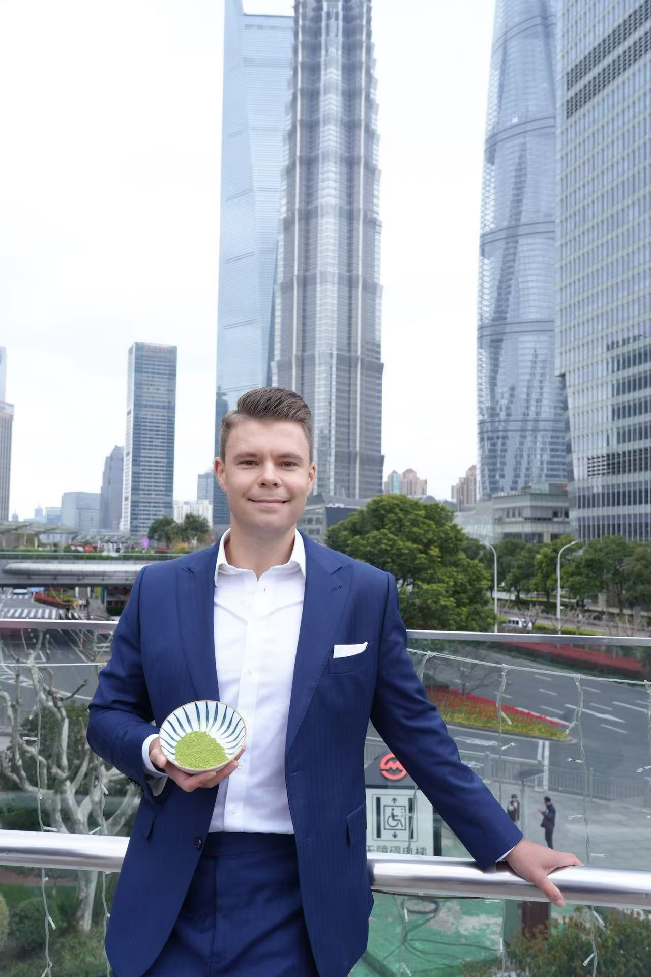 Kay Glaeske holding matcha with Shanghai skyline
