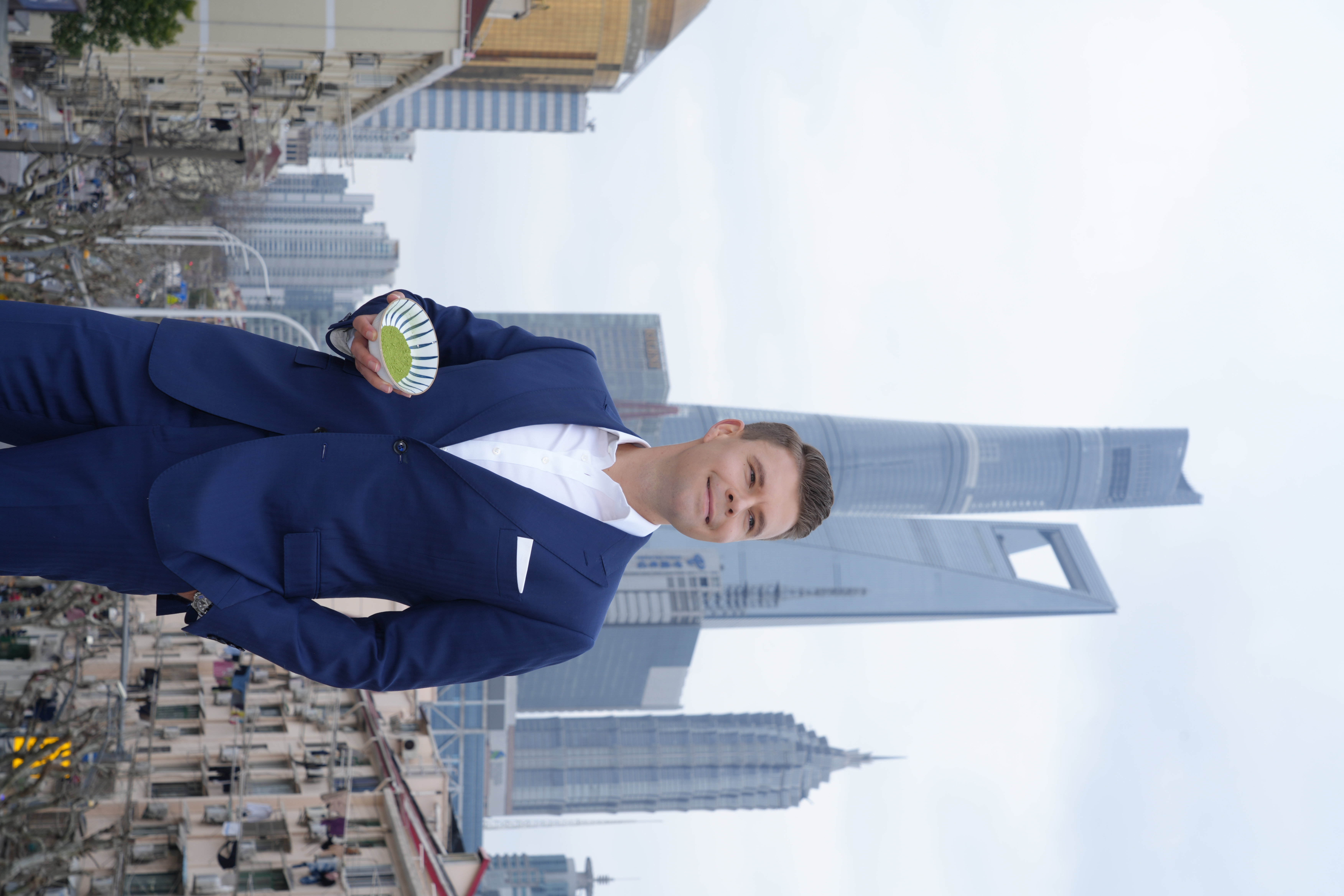 Kay Glaeske holding matcha with Shanghai skyline
